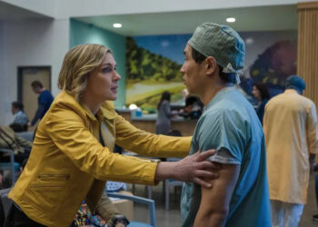 Rhea Seehorn as Carol Sturka grabbing a doctor by the shoulders in Pluribus