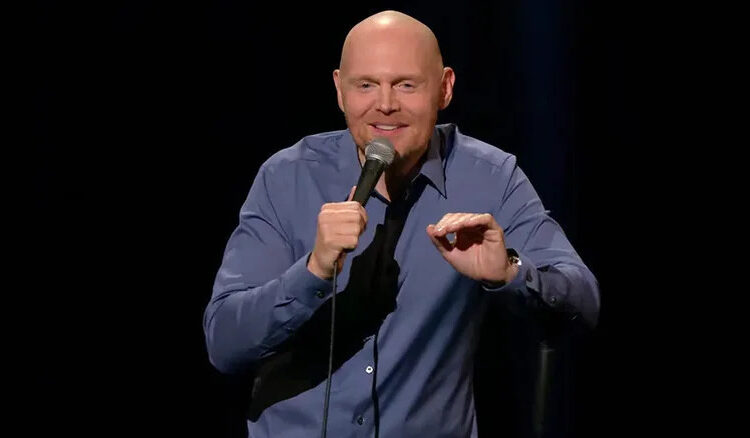Bill Burr grasps a microphone and tells jokes during Live at Red Rocks