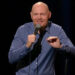 Bill Burr grasps a microphone and tells jokes during Live at Red Rocks