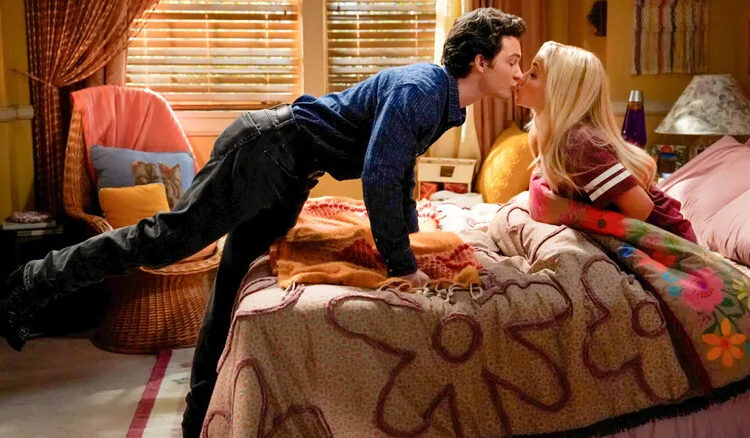 Georgie and Mandy kiss in their bedroom in