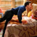 Georgie and Mandy kiss in their bedroom in