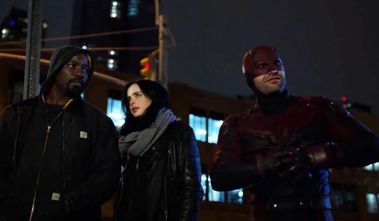 Mike Colter's Luke Cage stands next to Krysten Ritter's Jessica Jones and Charlie Cox's Daredevil in The Defenders