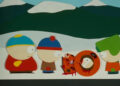 Kenny, dead, with Cartman, Stan, and Kyle looking at him on South Park