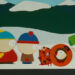 Kenny, dead, with Cartman, Stan, and Kyle looking at him on South Park