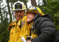 Gabi and Vince walk through the woods in Fire Country