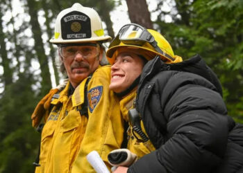 Gabi and Vince walk through the woods in Fire Country