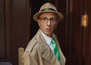 Steve looking shocked in a detective's coat and hat while stepping out of his front door in Blue's Big City Adventure