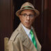 Steve looking shocked in a detective's coat and hat while stepping out of his front door in Blue's Big City Adventure