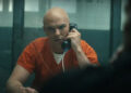 Nicholas Hoult as Lex Luthor talking to Frank Grillo as Rick Flag in jail in Peacemaker season 2