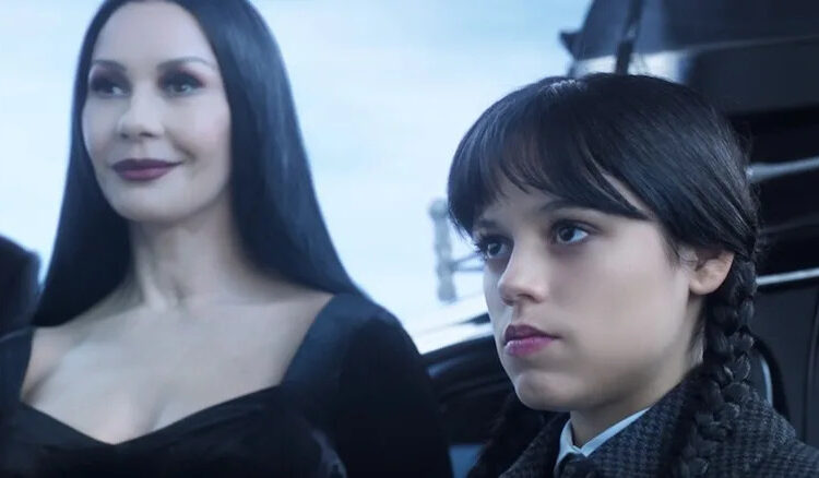 Morticia smiles while Wednesday sulks in Season 1 of Wednesday