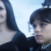 Morticia smiles while Wednesday sulks in Season 1 of Wednesday