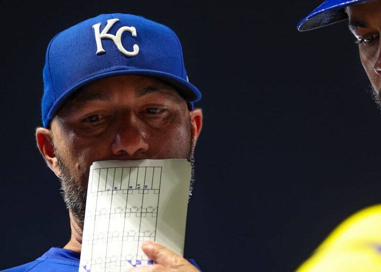 Royals hitting coach Alex Zumwalt goes over strategy with Maikel Garcia during a game against the Minnesota Twins.