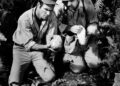 Actors Burt Reynolds and Roger C. Carmel find a skull in a scene from the movie "Skullduggery" circa 1970.