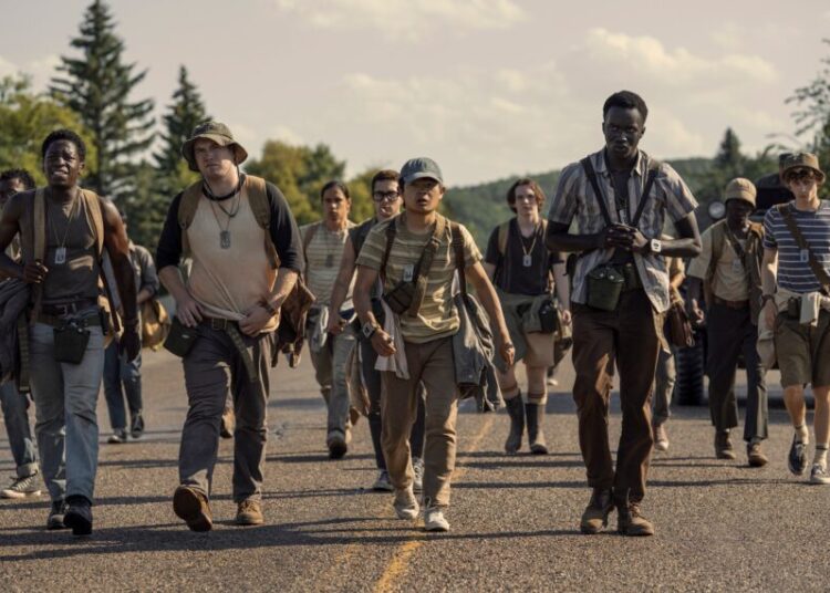 David Jonsson as McVries, Cooper Hoffman as Garraty, Jordan Gonzalez as Harkness, Ben Wang as Olson, and Tut Nyuot as Baker in The Long Walk. Photo Credit: Murray Close/Lionsgate