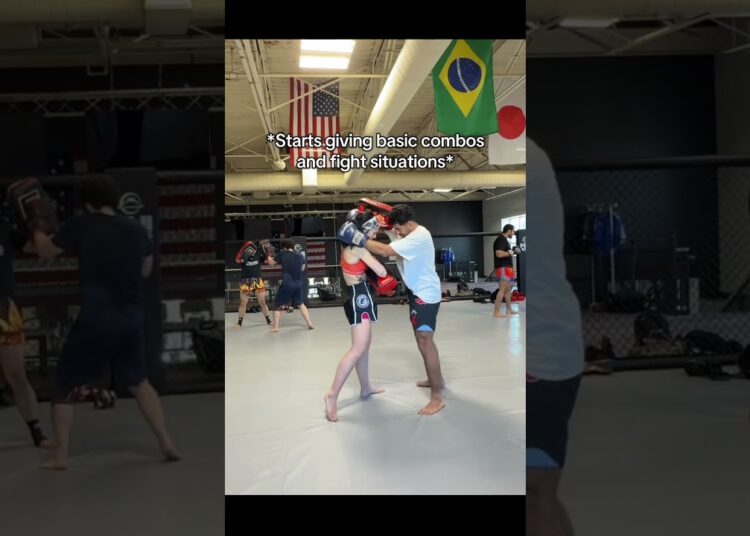 Beginner woman martial artists holding properly holds pads