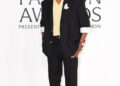 A$AP Rocky, CHANEL menswear, 2025 CFDA Fashion Awards menswear, Style Icon Award, black silk gabardine suit, yellow knit top, ecru silk trunk, CHANEL belt, two-tone shoes