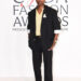 A$AP Rocky, CHANEL menswear, 2025 CFDA Fashion Awards menswear, Style Icon Award, black silk gabardine suit, yellow knit top, ecru silk trunk, CHANEL belt, two-tone shoes