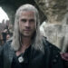 Geralt walks through a crowd in The Witcher