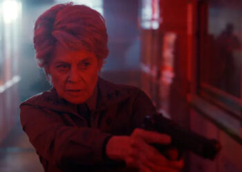 Dr. Kay aiming a gun