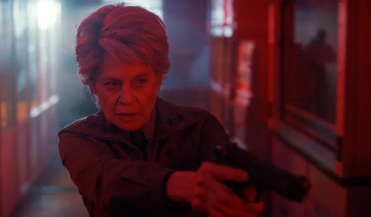 Dr. Kay aiming a gun
