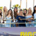 The cast of The Secret Lives of Mormon Wives pose for a photo on a bus.