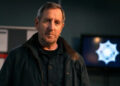 Colly gazes into the camera in Blue Lights