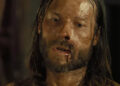 Guy Pearce's Charlie Burns is seen bloodied in closeup in The Proposition
