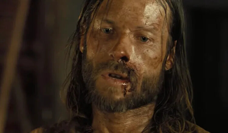 Guy Pearce's Charlie Burns is seen bloodied in closeup in The Proposition