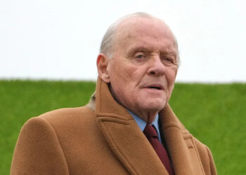 Anthony Hopkins wears tan coat.