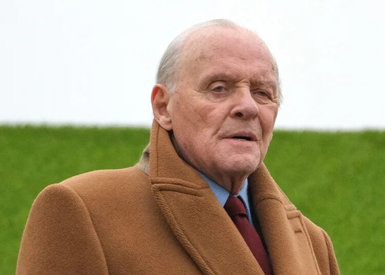 Anthony Hopkins wears tan coat.