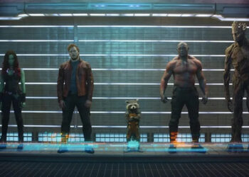 Zoe Saldaña as Gamora, Chris Pratt as Peter Quill, Bradley Cooper as Rocket Raccoon, Dave Bautista as Drax, and Vin Diesel as Groot stand in a lineup in Guardians of the Galaxy