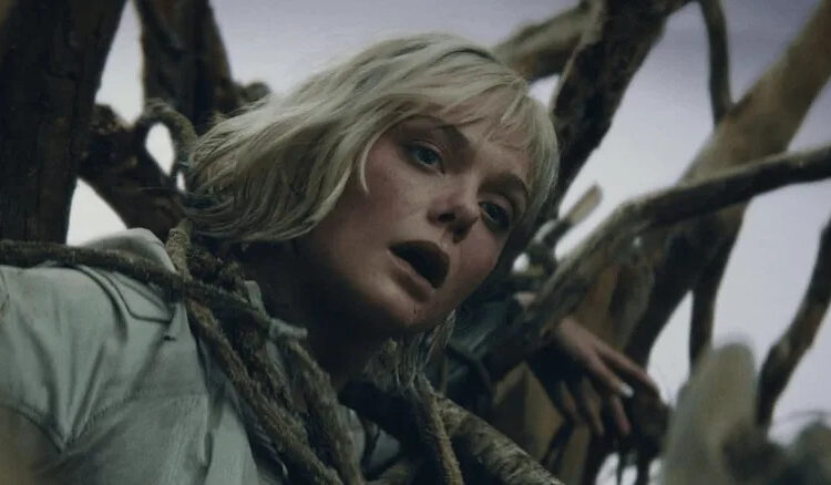 Elle Fanning as Thia wrapped up in tree branches in Predator: Badlands