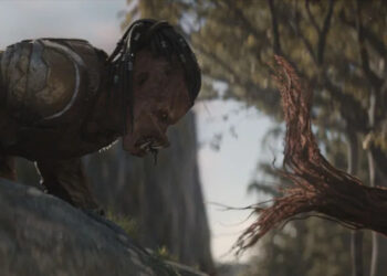 Dimitrius Schuster-Koloamatangi as Dek facing off with a tree tentacle in Predator: Badlands