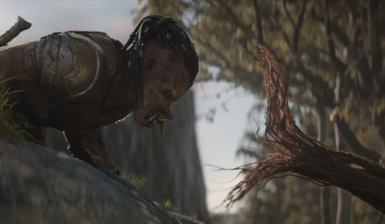 Dimitrius Schuster-Koloamatangi as Dek facing off with a tree tentacle in Predator: Badlands