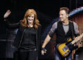 Bruce Springsteen and Patti Scialfa take the stage with the E Street Band to perform the final concert at Giants Stadium in East Rutherford, New Jersey, Friday, October 9, 2009.