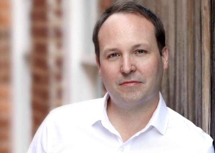 white man wears white shirt outdoors. Grant Knox