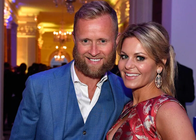Valeri Bure and Candace Cameron smile for a photo