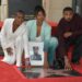 Letitia Wright, Simone Ledward Boseman and Michael B. Jordan kneel on Hollywood Walk of Fame, each with a hand on a new star
