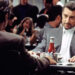 Robert De Niro as Neil McCauley sitting in a restaurant during the '90s thriller movie Heat. .