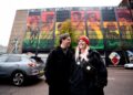 Mural artists Friz (Marian Noone) and Gerry Norman in front of new UNESCO City of Music mural on the Telegraph Building.