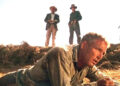 Three men standing over Luke in "Cool Hand Luke"