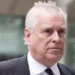PA Media Andrew Mountbatten Windsor has grey hair. He is looking to the right. You can see the top of a suit and black tie.