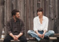 Dakota Johnson's Lucy Mason sits alongside Chris Evans' John Pitts in Materialists