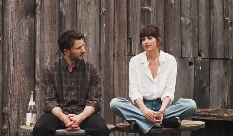 Dakota Johnson's Lucy Mason sits alongside Chris Evans' John Pitts in Materialists