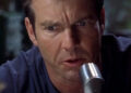 Dennis Quaid speaks into a ham radio microphone as Frank Sullivan in Frequency