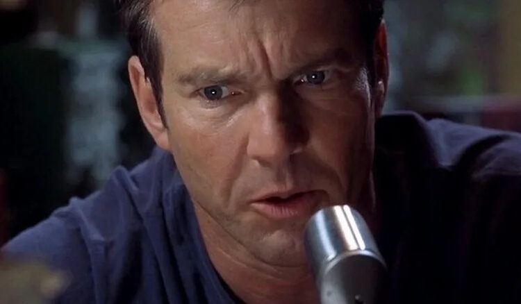 Dennis Quaid speaks into a ham radio microphone as Frank Sullivan in Frequency