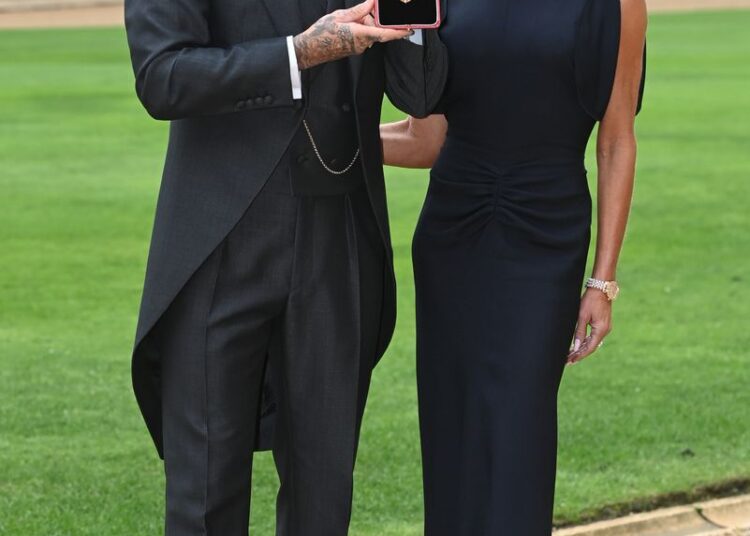 Sir David Beckham with wife Victoria after he was made a Knight Bachelor at an investiture ceremony at Windsor Castle on November 4, 2025 in Windsor, England.