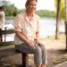 Duchess Sophie sitting on a bench wearing a floral top and gray pants