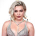 Florence Pugh poses on the red carpet at the 96th Annual Academy Awards in a silver dress.