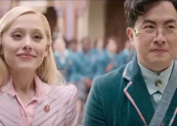 Ariana Grande and Bowen Yang in Wicked sitting next to each other.